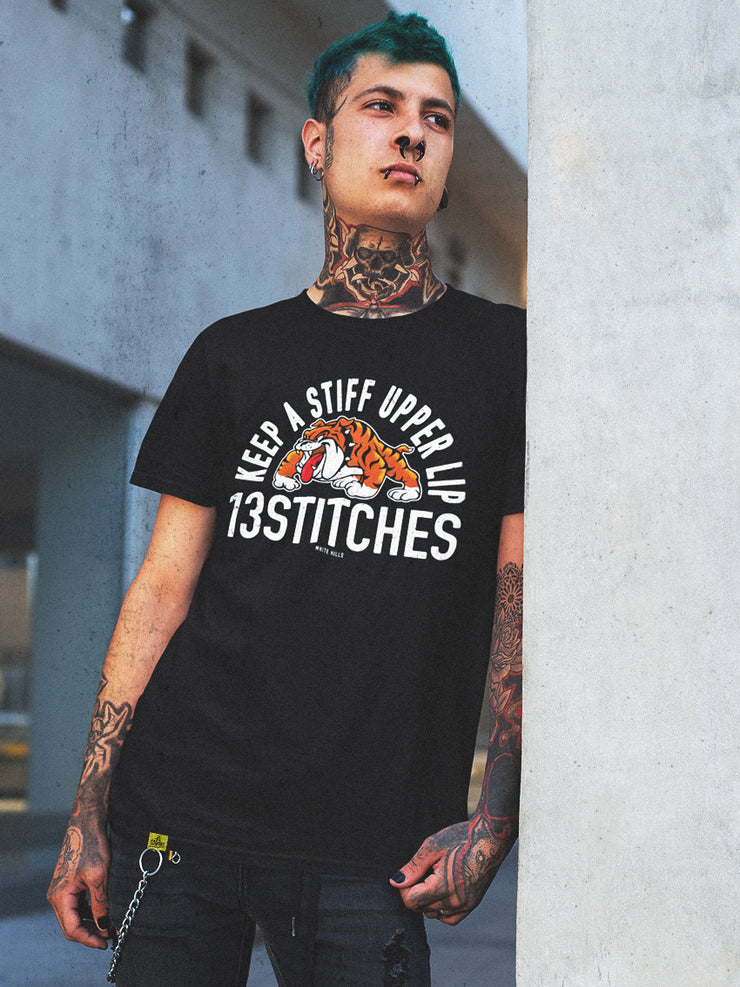 13stitches-tattoo-man-wearing-a-black-tshirt-with-streetwear-bulldog-design