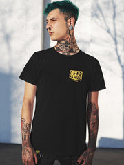 tattooed man wearing black t-shirt with skull design, yellow