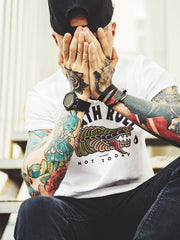 13stitches-tattooed-man-wearing-white-t-shirt-with-tattoo-design-of-an-aligator-crocodile